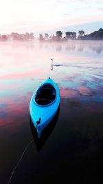 High angle view of kayak moored in lake with reflection