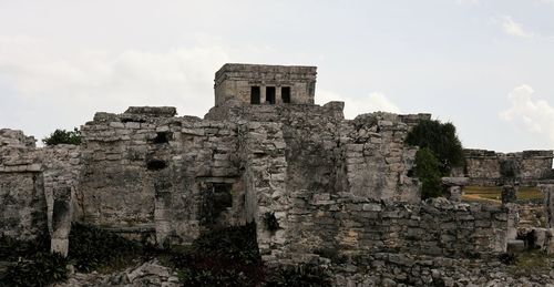 Old ruins of building against cloudy sky