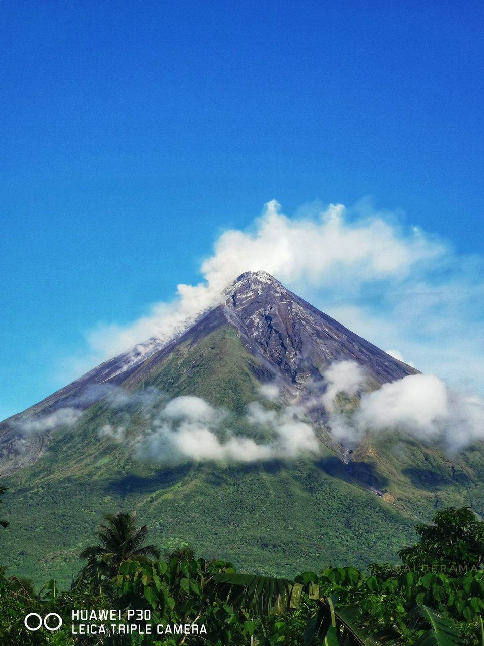 volcano, mountain, sky, stratovolcano, smoke, landscape, volcanic landscape, environment, cloud, beauty in nature, geology, volcanic crater, scenics - nature, nature, active volcano, no people, land, erupting, cinder cone, plant, non-urban scene, travel destinations, blue, day, mountain peak, outdoors, travel, plain, tree, plateau, physical geography, tranquil scene, lava dome, tourism