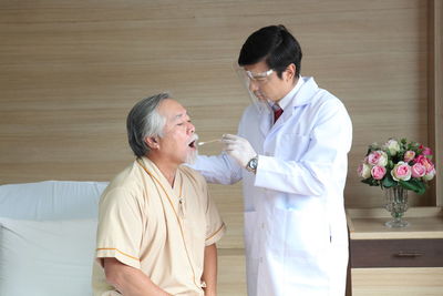 Doctor examining patient at home