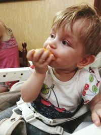 Close-up of cute baby girl sitting at home