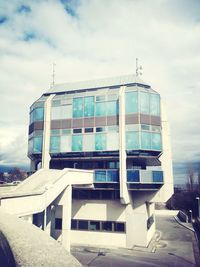 Buildings against cloudy sky