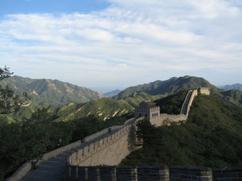 Scenic view of mountains against cloudy sky