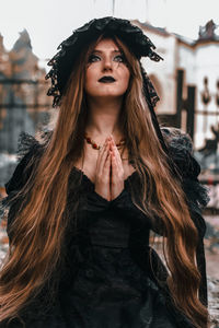 Portrait of beautiful young woman standing outdoors