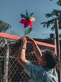 Portrait of young man holding balloons