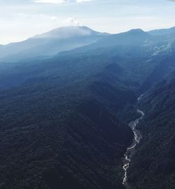 Aerial view of mountain range against sky in foggy weather