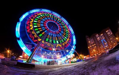 Illuminated ferris wheel in amusement park