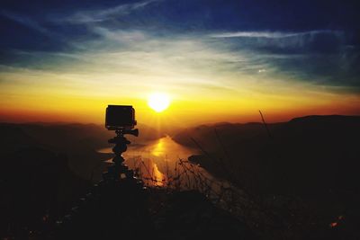 Silhouette landscape against sky during sunset