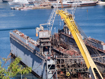 High angle view of cranes at commercial dock