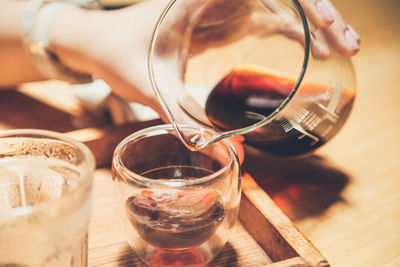 Pouring speciality coffee to the glass cup