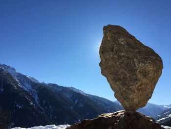 Scenic view of snowcapped mountains against clear blue sky