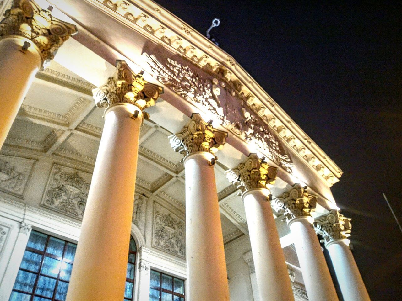 low angle view, architecture, built structure, architectural column, building exterior, column, history, national landmark, sky, travel destinations, architectural feature, outdoors, famous place, tall - high, city life, facade, day, monument, tourism, no people, spire, capital cities