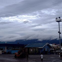 Buildings against cloudy sky