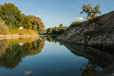 Reflection of trees in lake against sky