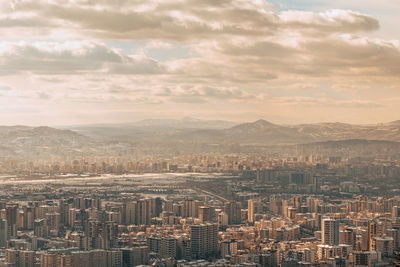 High angle view of buildings in city against sky