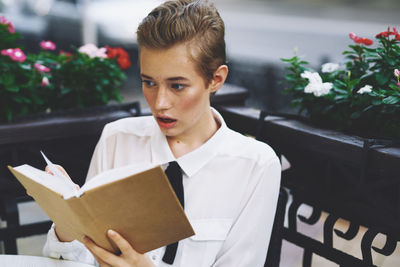 Portrait of a beautiful young woman holding paper