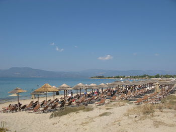 Panoramic view of people on beach against sky