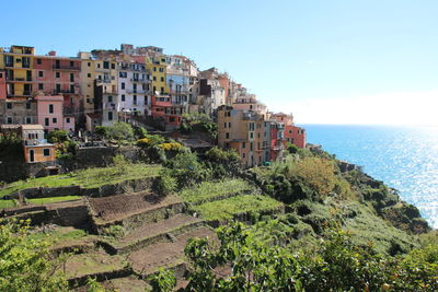 Panoramic shot of city by sea against clear sky