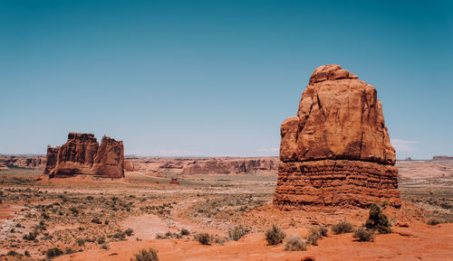 Rock formations on landscape against clear sky