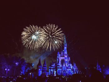 Low angle view of firework display at night