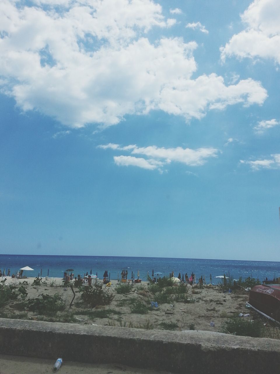 sea, beach, sky, water, horizon over water, cloud - sky, shore, scenics, tranquil scene, cloud, beauty in nature, sand, large group of people, nature, tranquility, vacations, cloudy, day, incidental people