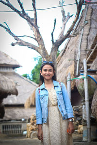 Portrait of smiling young woman standing outdoors