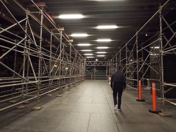 Rear view of man walking in subway