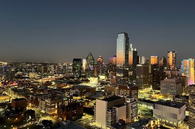 High angle view of city lit up at night