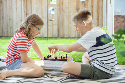 Side view of men sitting in playing