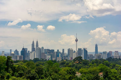 View of cityscape against cloudy sky