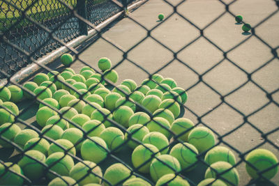 Full frame shot of chainlink fence with tennis balls