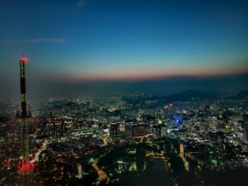 High angle view of city lit up at night