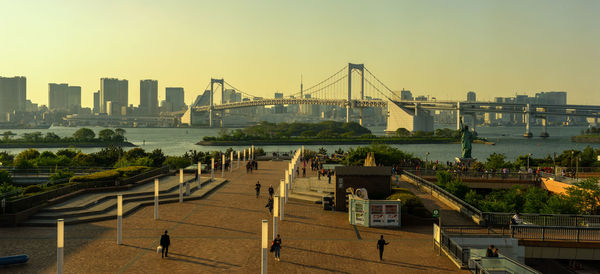 High angle view of bridge over river by buildings against sky