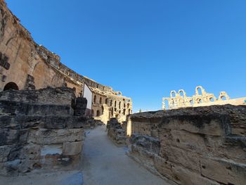 Low angle view of old building against blue sky