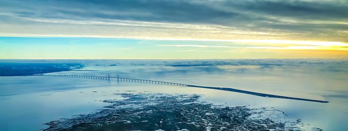 Scenic view of frozen lake against sky during winter