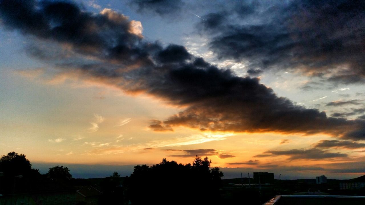 sunset, sky, silhouette, cloud - sky, scenics, beauty in nature, orange color, dramatic sky, cloudy, tranquil scene, cloud, tranquility, nature, tree, idyllic, moody sky, building exterior, weather, built structure, overcast