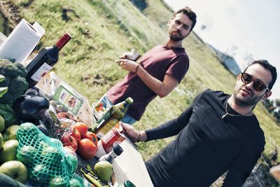 Young man with fruits in container