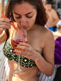 Close-up of a young woman drinking glass