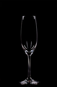 Close-up of wineglass against black background
