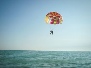 Multi colored parachute flying over sea