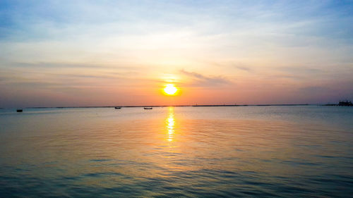 Scenic view of sea against romantic sky at sunset