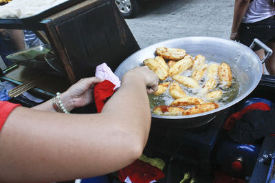 Cropped image of person holding food