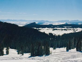 Scenic view of snow covered mountains against sky