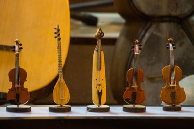 Close-up of string instrument figurines on table