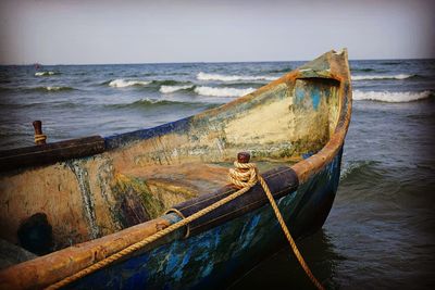 Boat moored on sea against sky