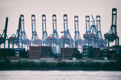 Row of cranes and containers in the harbor of hamburg, germany