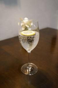 Close up glass of sparkling water on wooden table