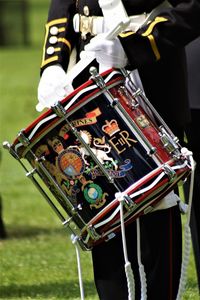 Midsection of man holding drum while standing on field