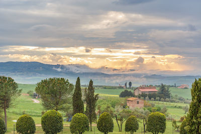 Sunset in tuscany with rolling hills in a rural landscape view
