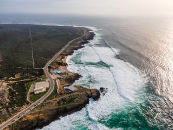 High angle view of land and sea against sky